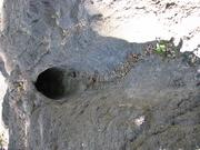 A tree mold in the lava rock, from where a tree fell, and was quickly surrounded by lava.