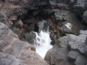 A blowhole, when waves crash against the cliff, they come gushing out of this cave that opens into the top of the cliff.  Actually, it has two openings.