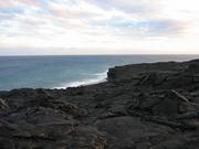 A little beach, but no way to reach it, and it is probably unstable rocks above it anyway. 