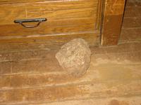 Multi-purpose security system - Use rock to block door.  Use rock to beat animal that came through door.  Use rock to prop open door so can run screaming from animal.