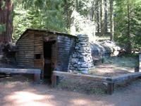 Tharp's log cabin, the first non-native person to leave in the area.