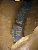 That is supposed to be water flowing over the marble of the cave, but the flash in the dark does some really odd things to the flowing water.