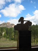 A model of what the Crazy Horse Memorial will look like when it is done, and the current scultpure in the distance.
